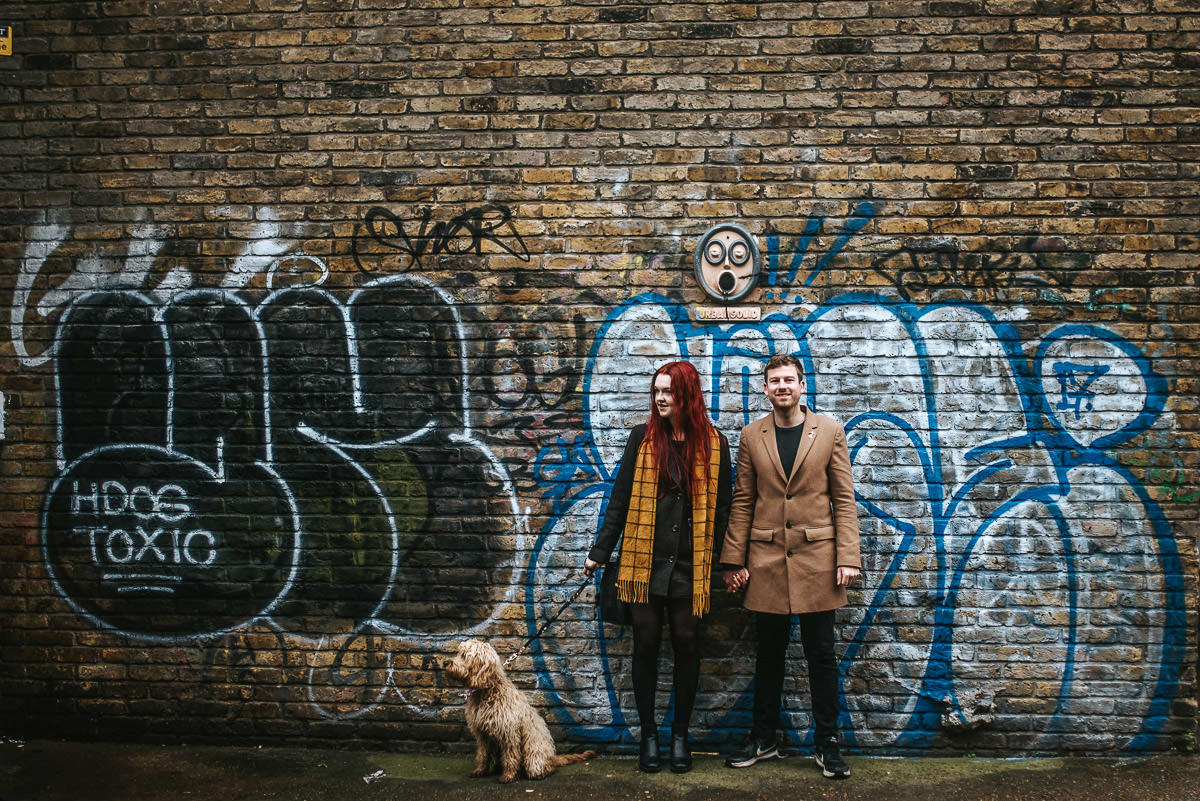 couple against brick lane graffiti
