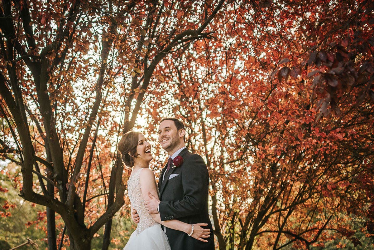 kent wedding happy couple with red backdrop