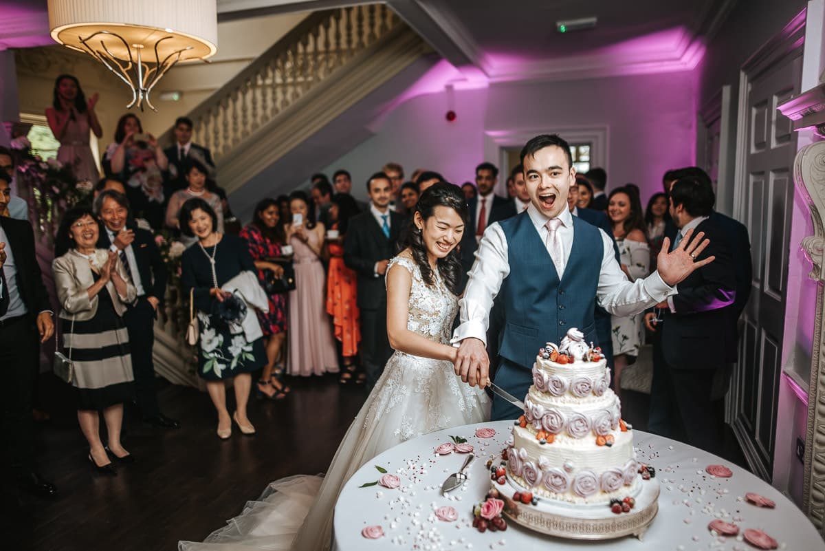 morden hall wedding cutting the cake