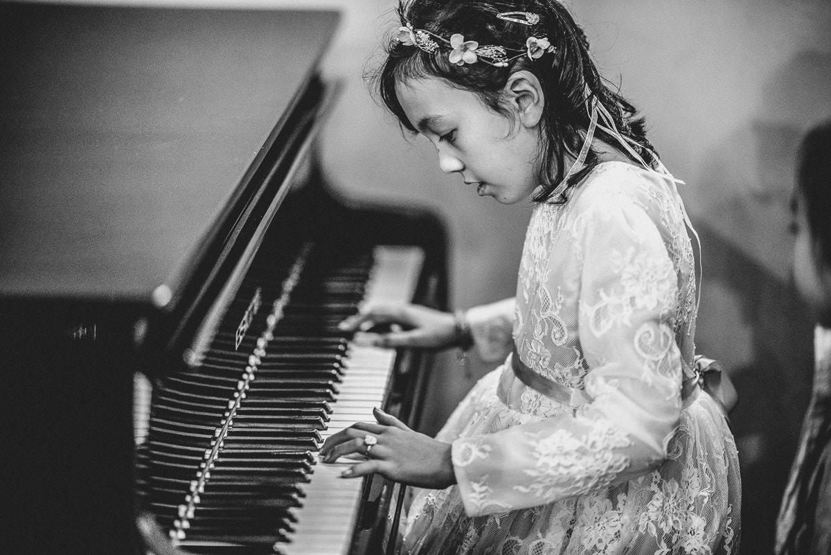 chinese girl playin piano at a wedding in hall place in london