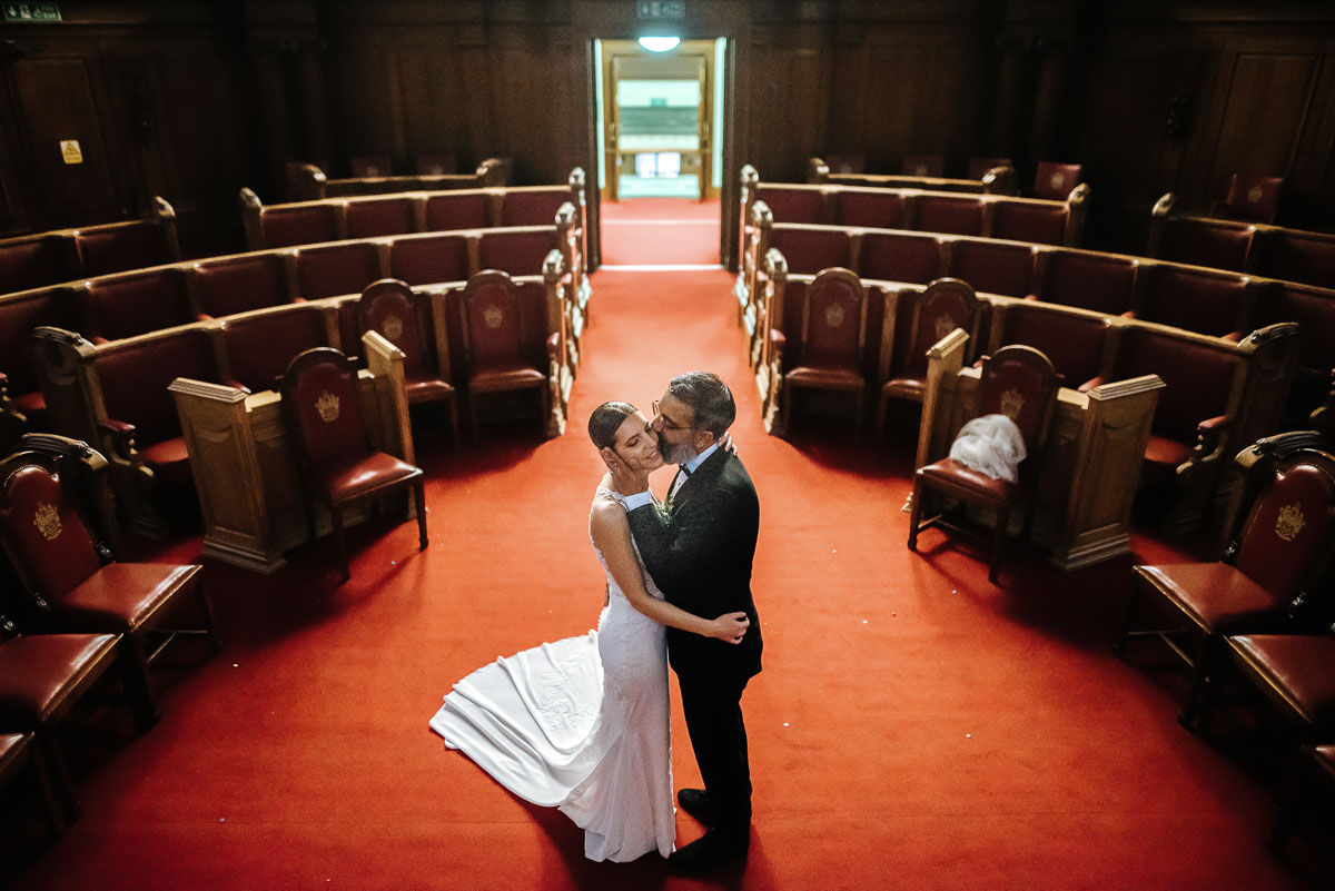 islington town hall wedding couple kissing in the main ceremony room