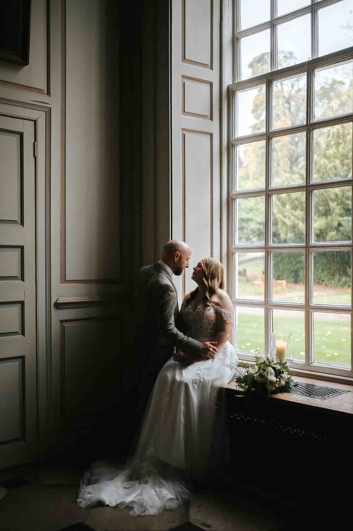 gosfield hall wedding couple in the window light