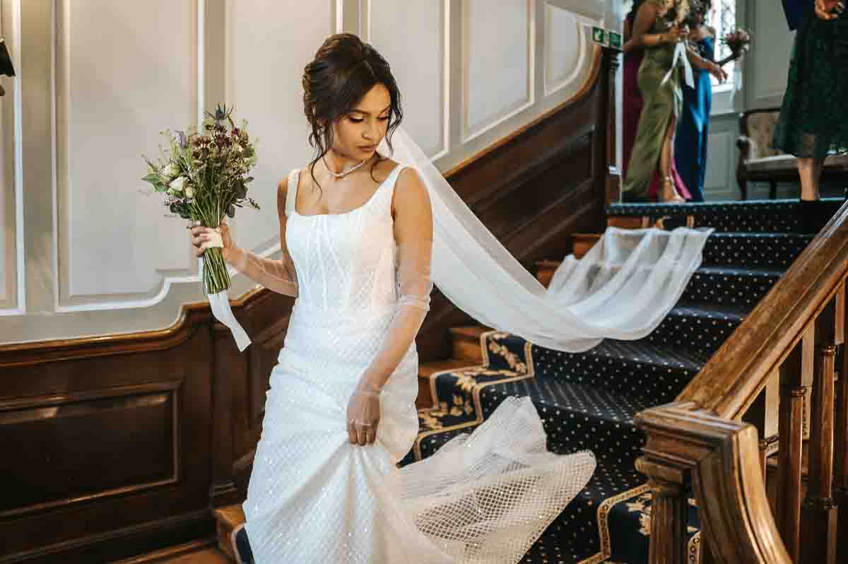 gosfield hall wedding bride going down the steps