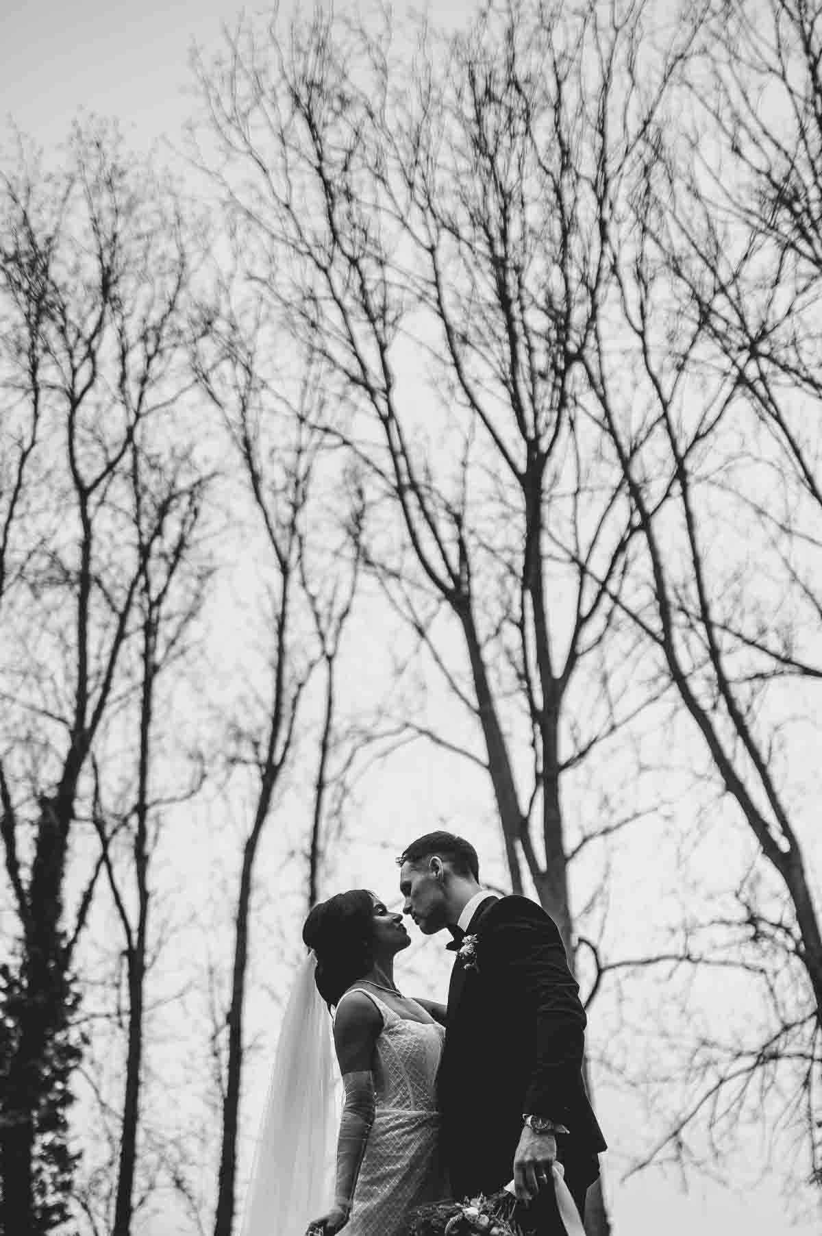 gosfield hall wedding couple posing by the trees