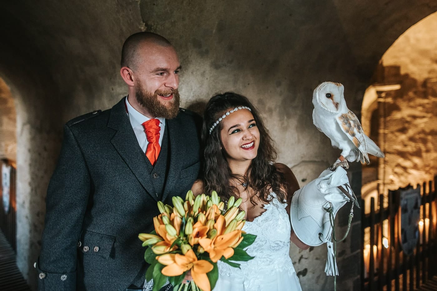 hedingham castle wedding bride and groom posing with an owl