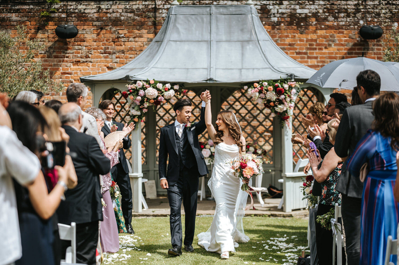 braxted park wedding ceremony newlyweds going down the isle