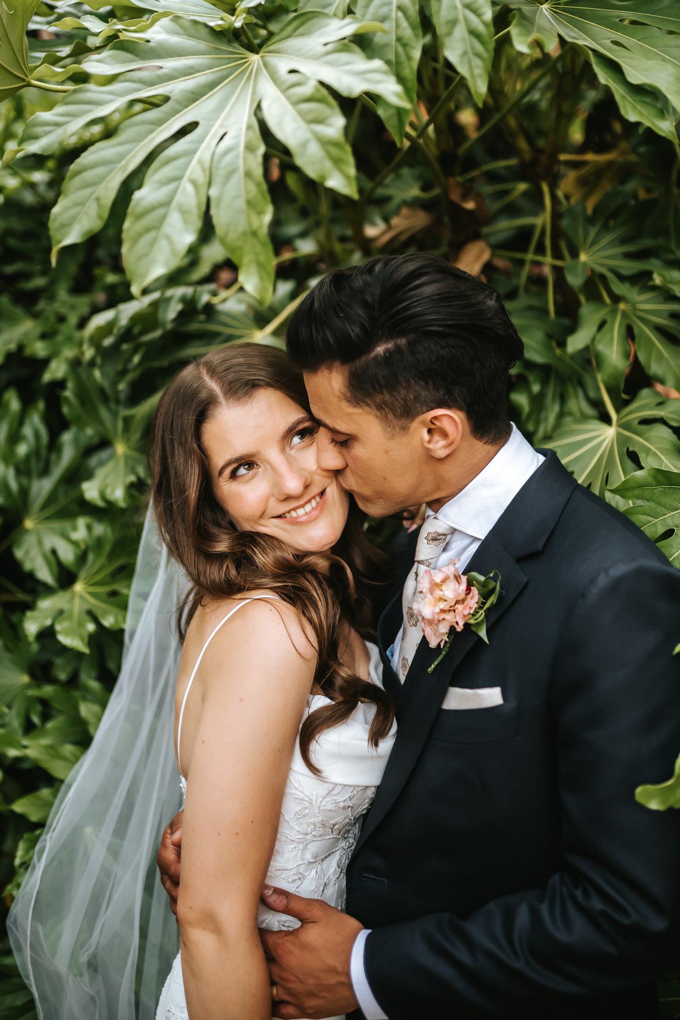 braxted park wedding couple portraits groom kissing the bride on the cheek