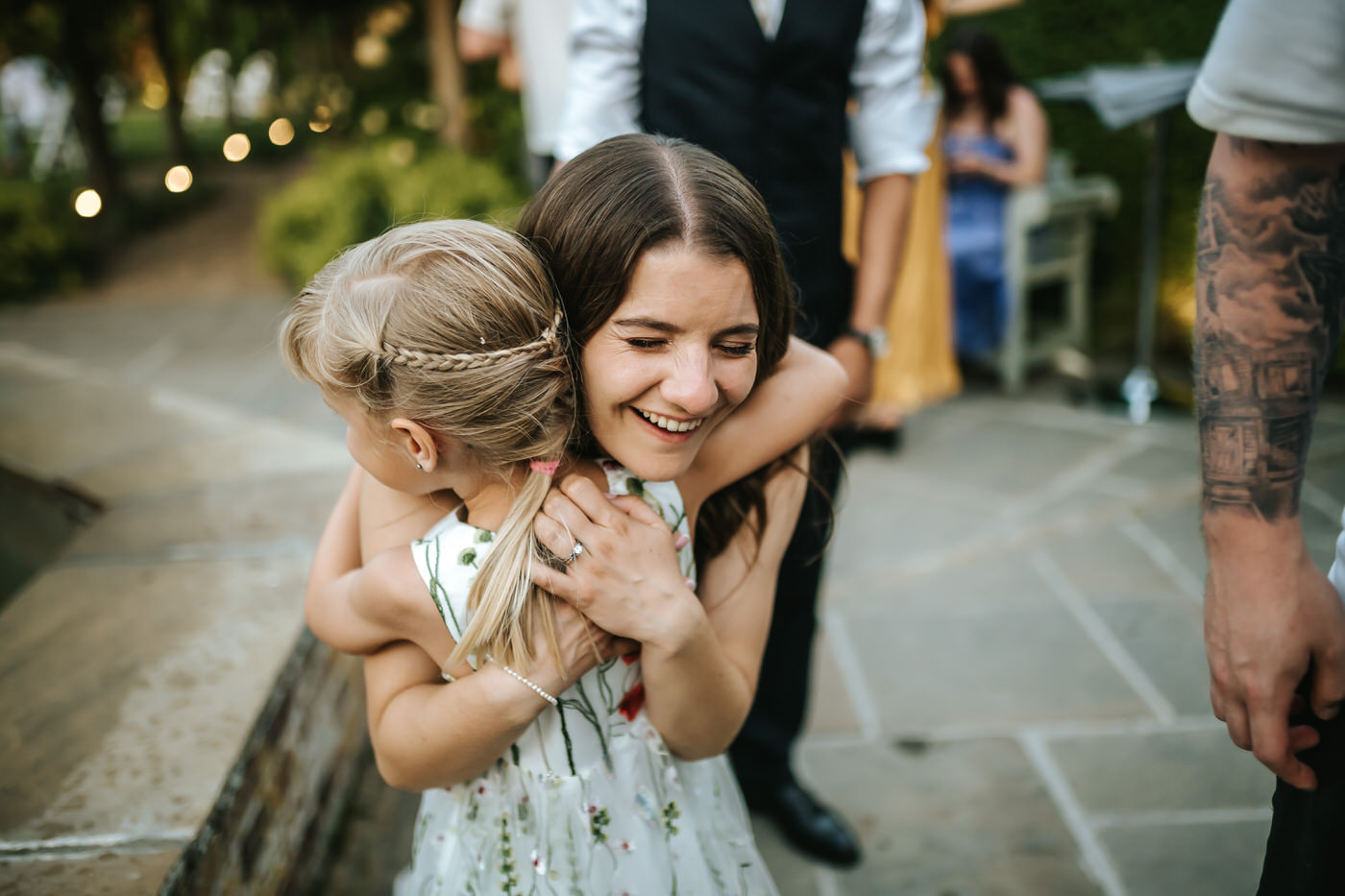 braxted park wedding bride hugging flower girl