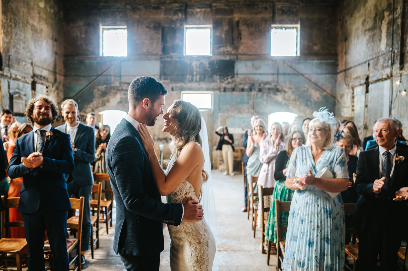 asylum chapel wedding newlyweds leaning for the first kiss