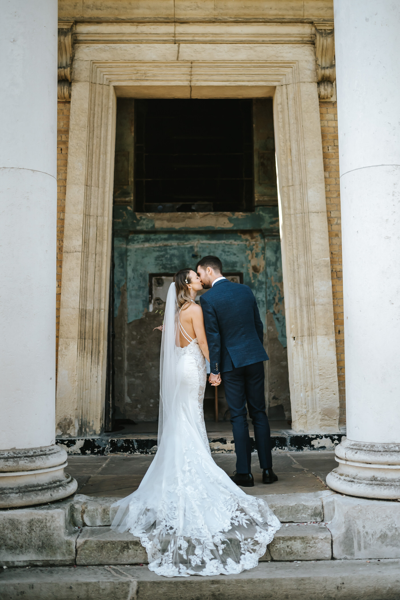 asylum chapel wedding bride and groom kissing with wedding dress on full display
