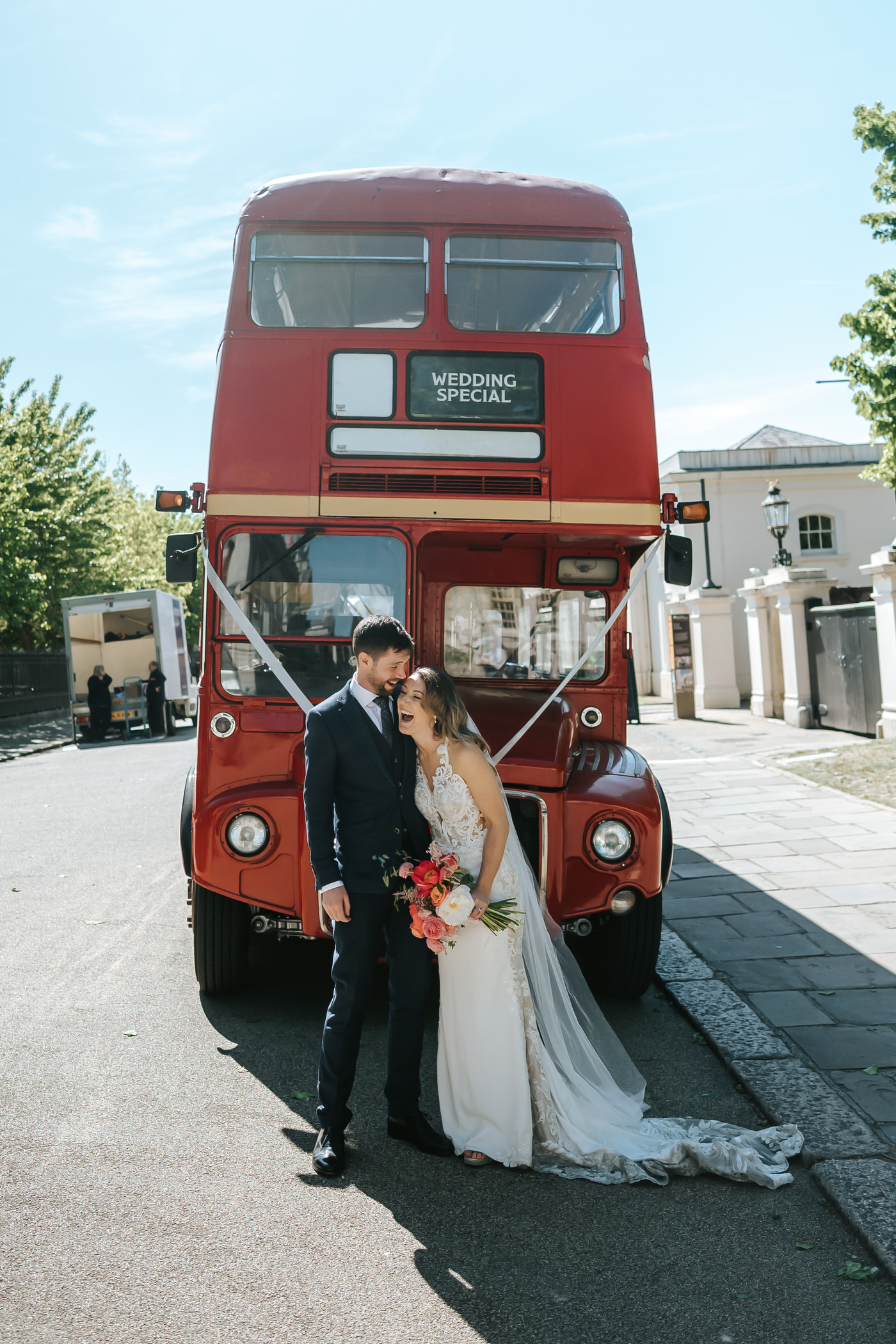 asylum chapel wedding bride and groom laughing in front of the wedding bus