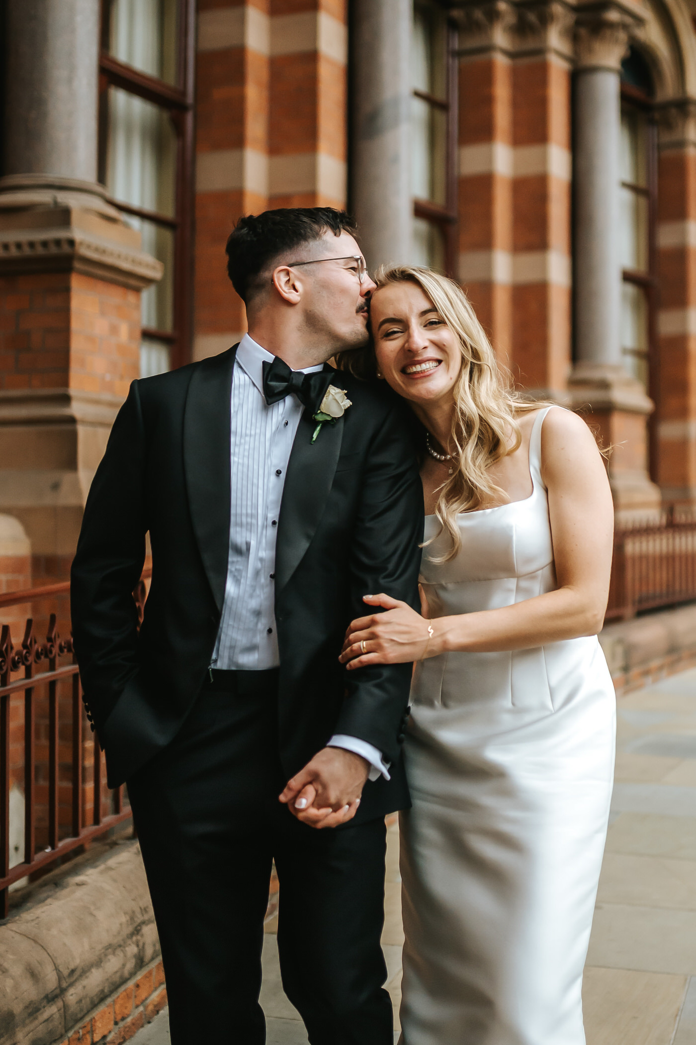 Camden Town Hall wedding couple shoot on nearby London streets groom kissing the bride on the forehead