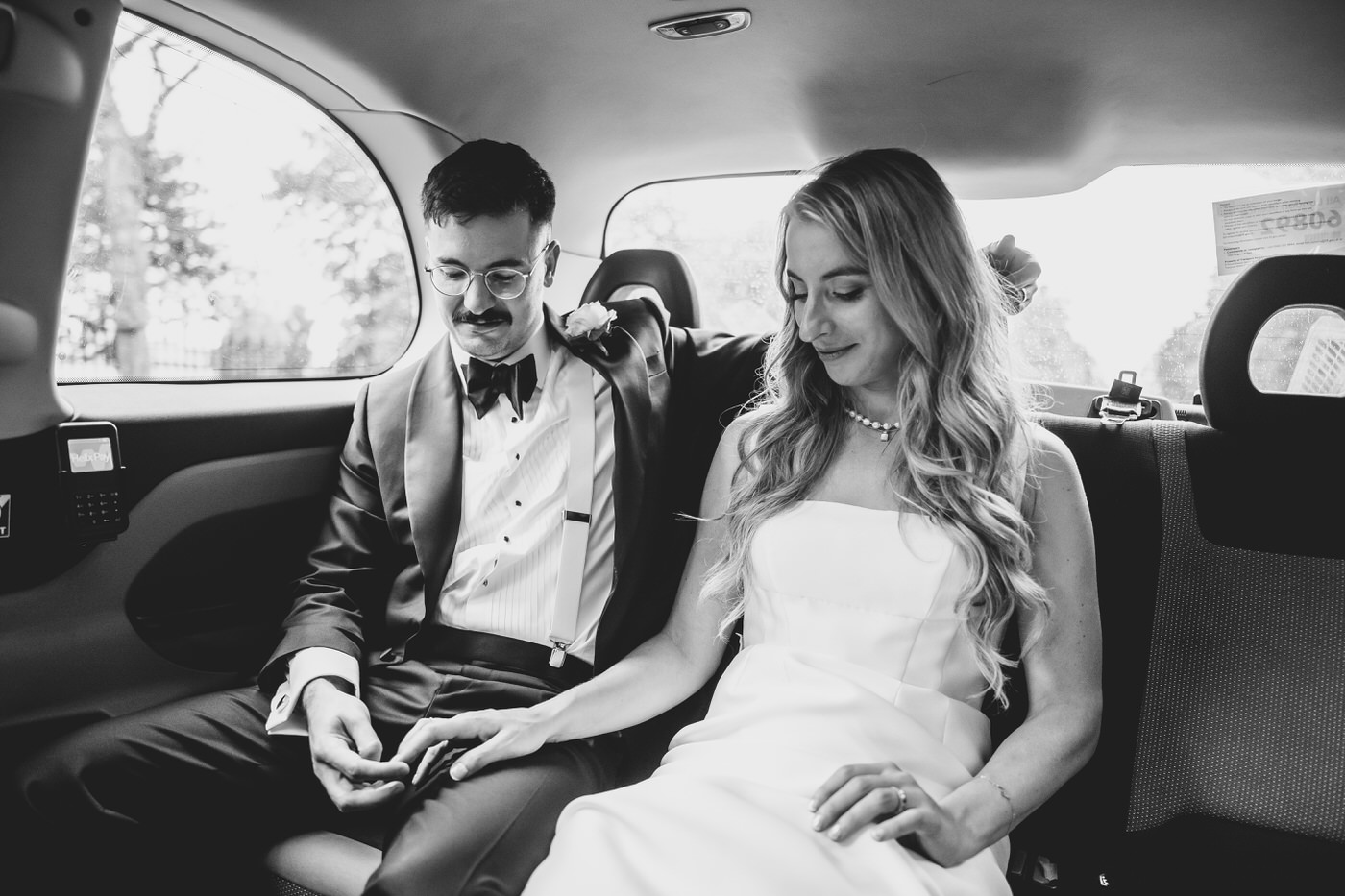 Camden Town Hall wedding couple touching hands in a taxi