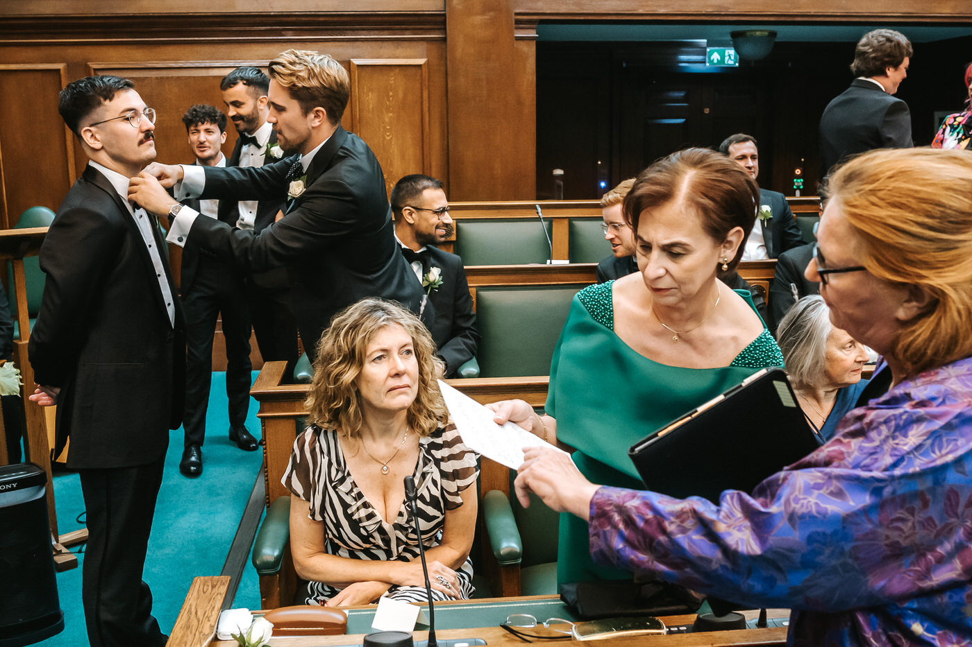 Camden Town Hall wedding best mad adjusting grooms button hole before the ceremony