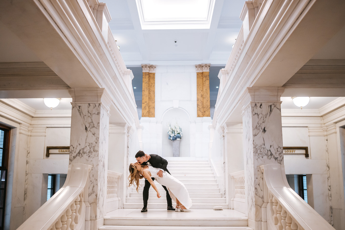 Camden Town Hall wedding couple shoot groom dipping nad kissing the bride on the town hall grand staircase
