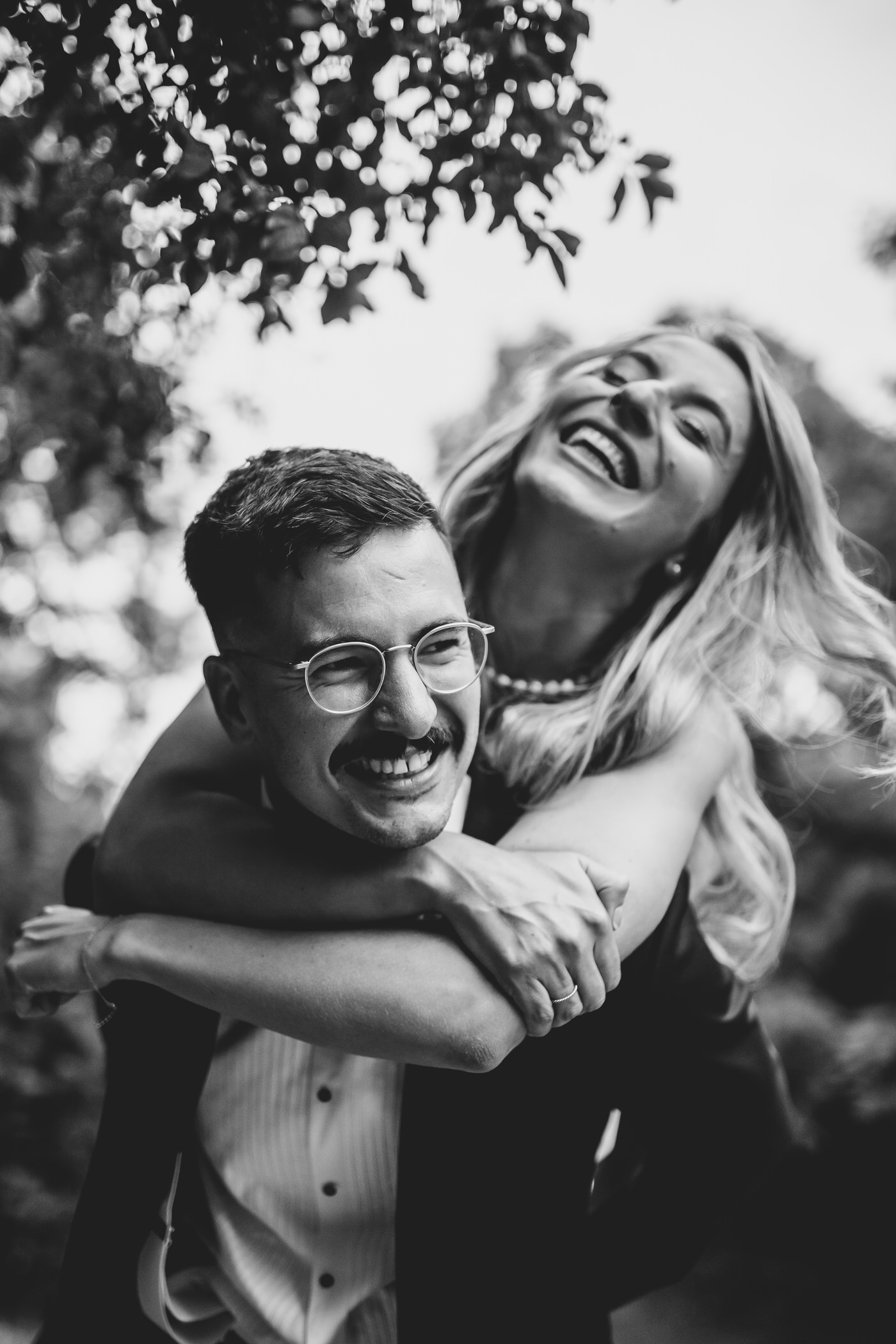 Camden Town Hall wedding couple shoot on nearby London streets groom giving bride piggy back ride