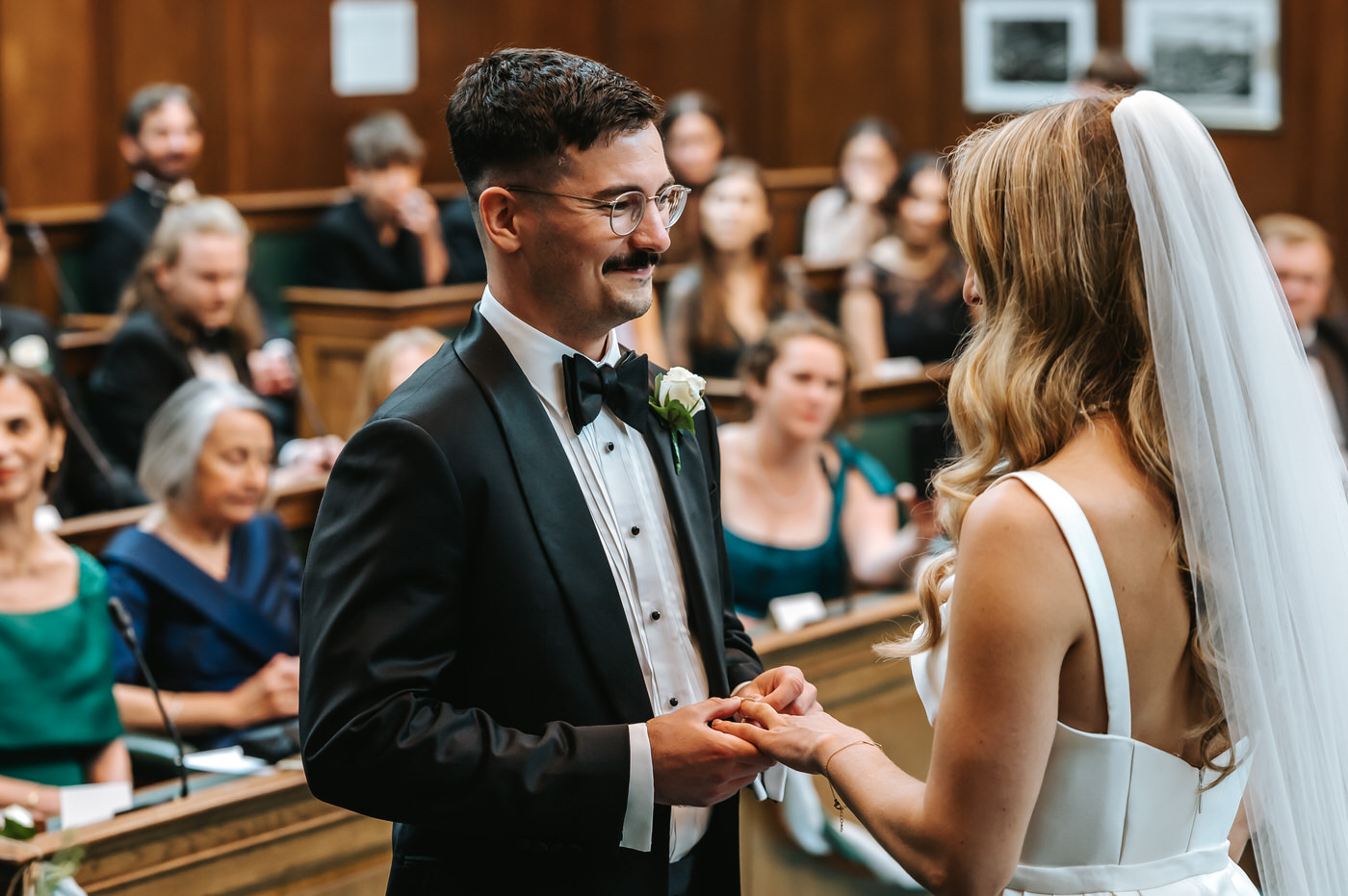 Camden Town Hall wedding ceremony groom putting the ring on