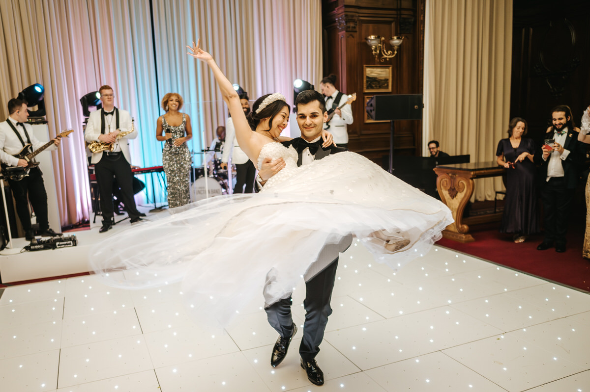 ashridge house wedding groom spinning with bride in his arms during the first dance