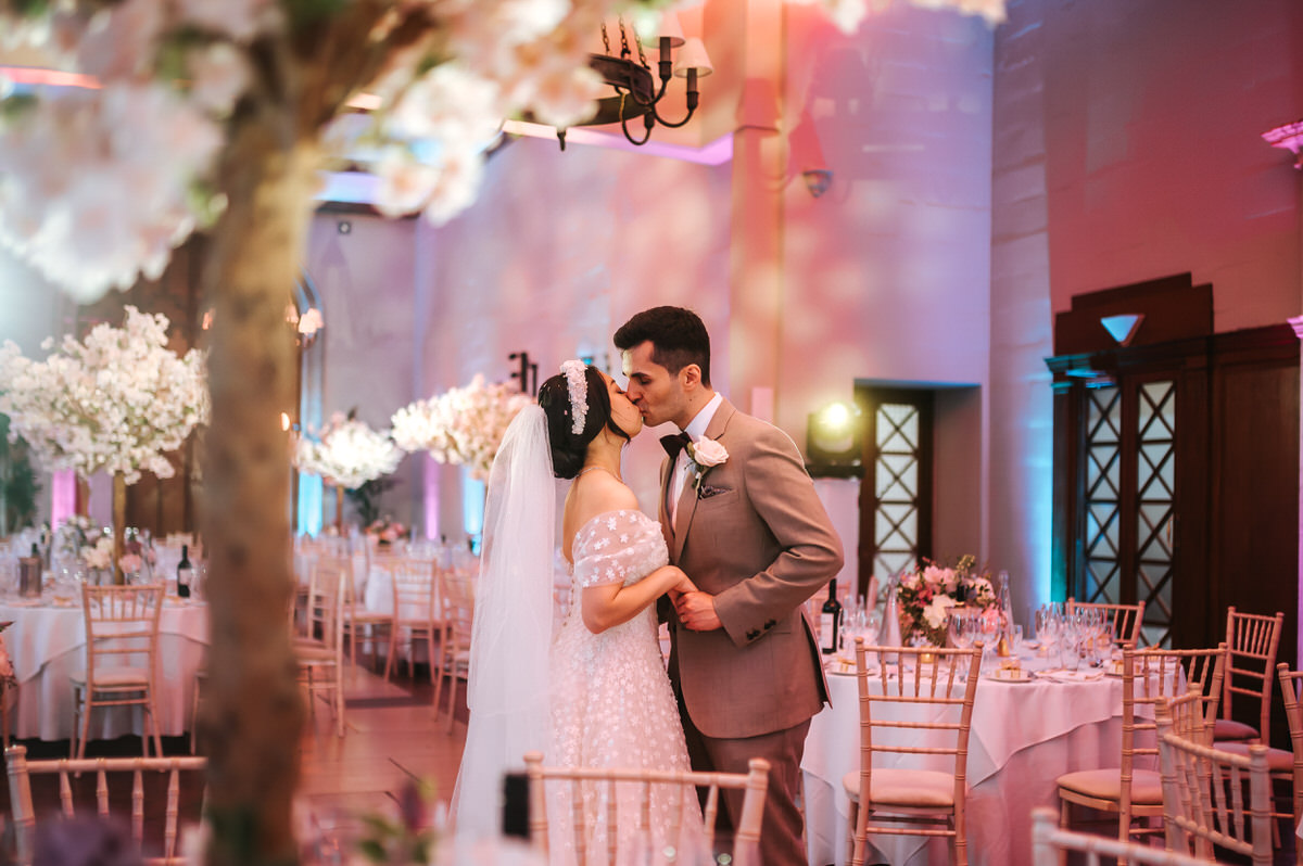 ashridge house wedding couple kissing in the wedding breakfast room