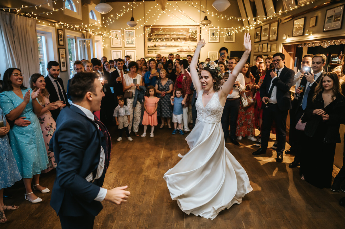london rowing club wedding wide shot of the first dance with bride spinning her dress