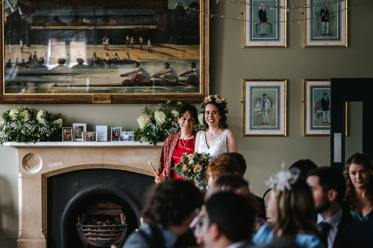 london rowing club wedding bride walking down the isle with her mum