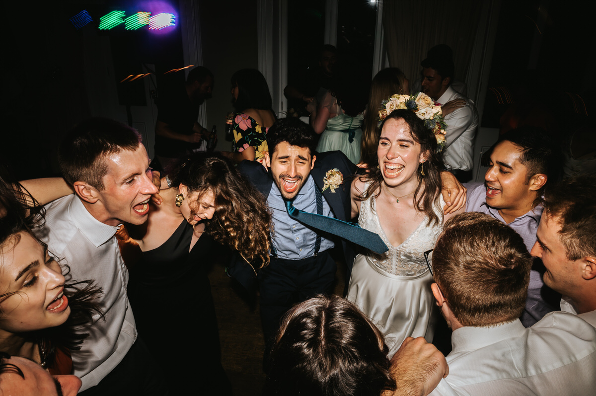 london rowing club wedding guests jumping