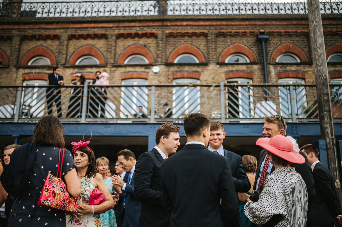 london rowing club wedding guests mingling ouside the venue