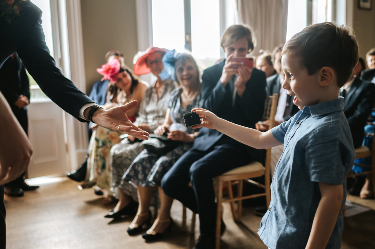 london rowing club wedding pageboy handin the rings to the newlyweds
