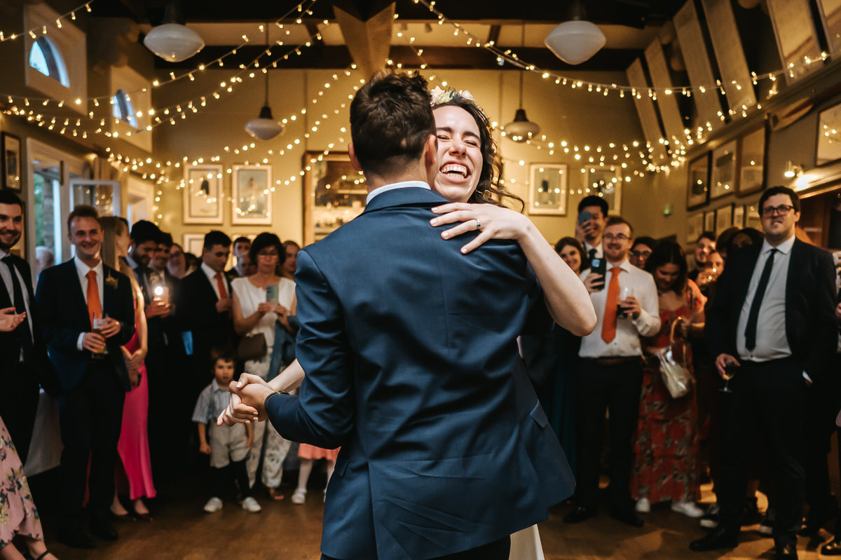 london rowing club wedding close up of bride laughing during the first dance