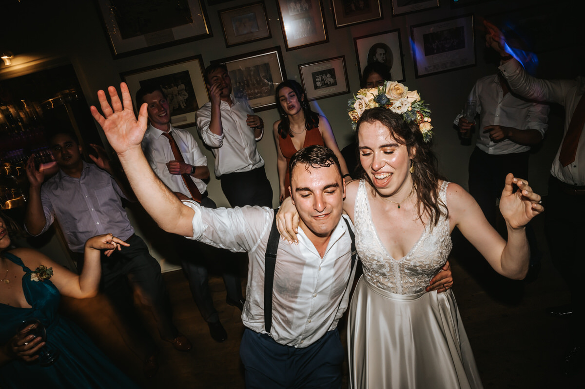london rowing club wedding bride and groom dancing franticly
