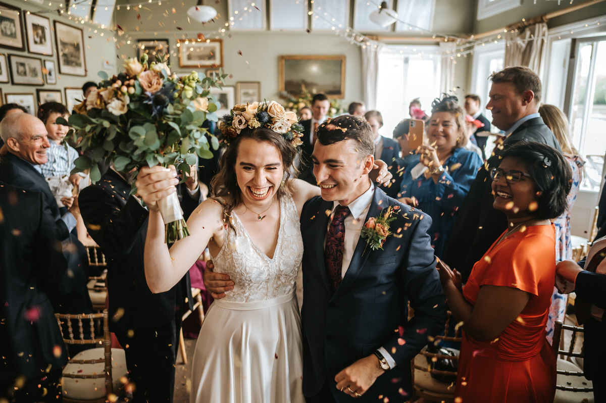 london rowing club wedding couple walking through confetti shower